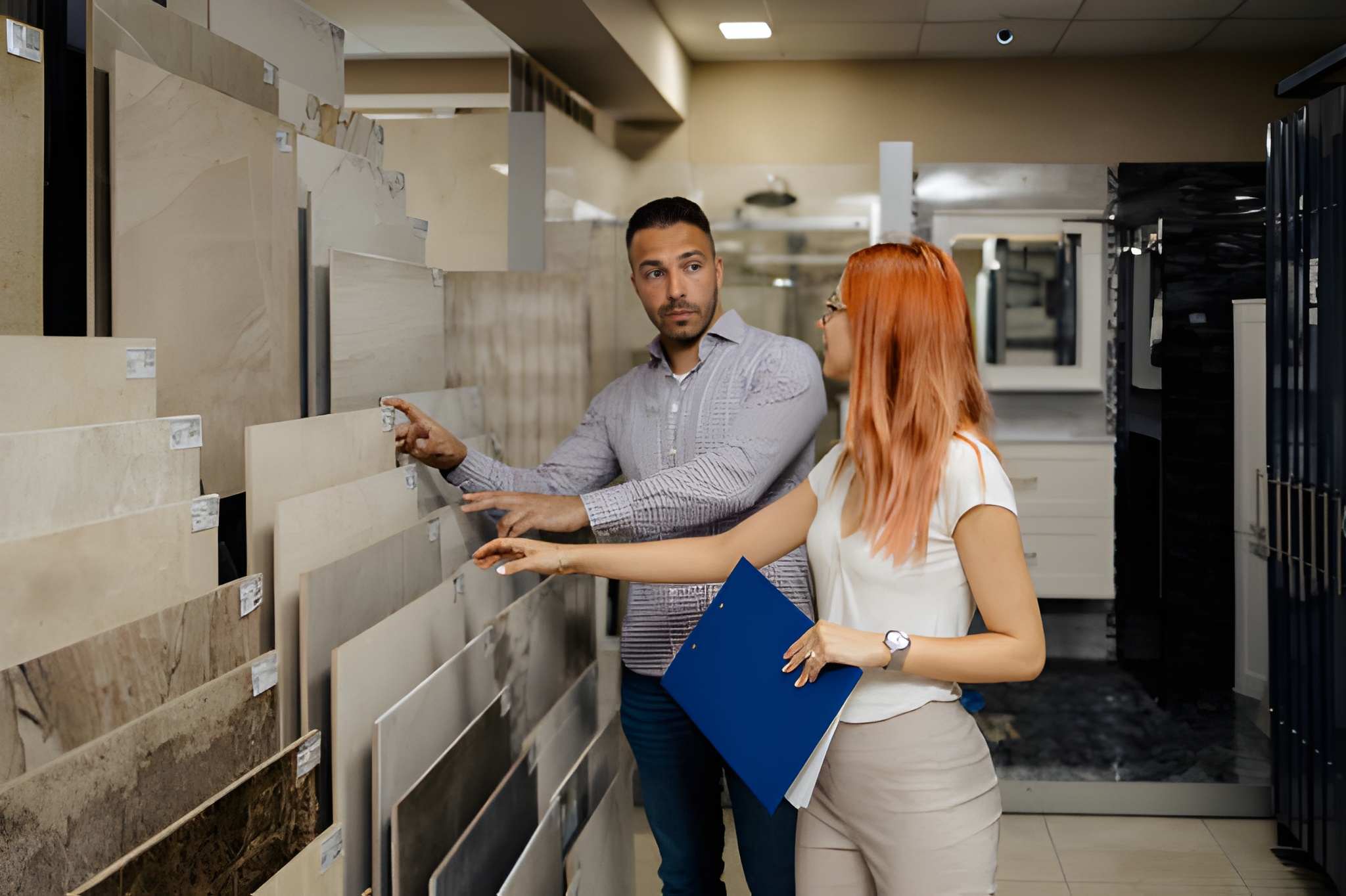 Customers reviewing tile samples—Tile stores West Palm Beach showroom with diverse stone and ceramic options